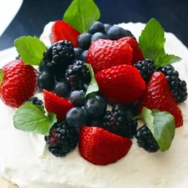 various berries on top of vanilla cream