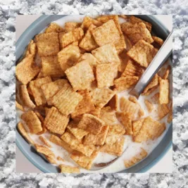 A bowl of cinnamon flavoured cereal with a salt border.