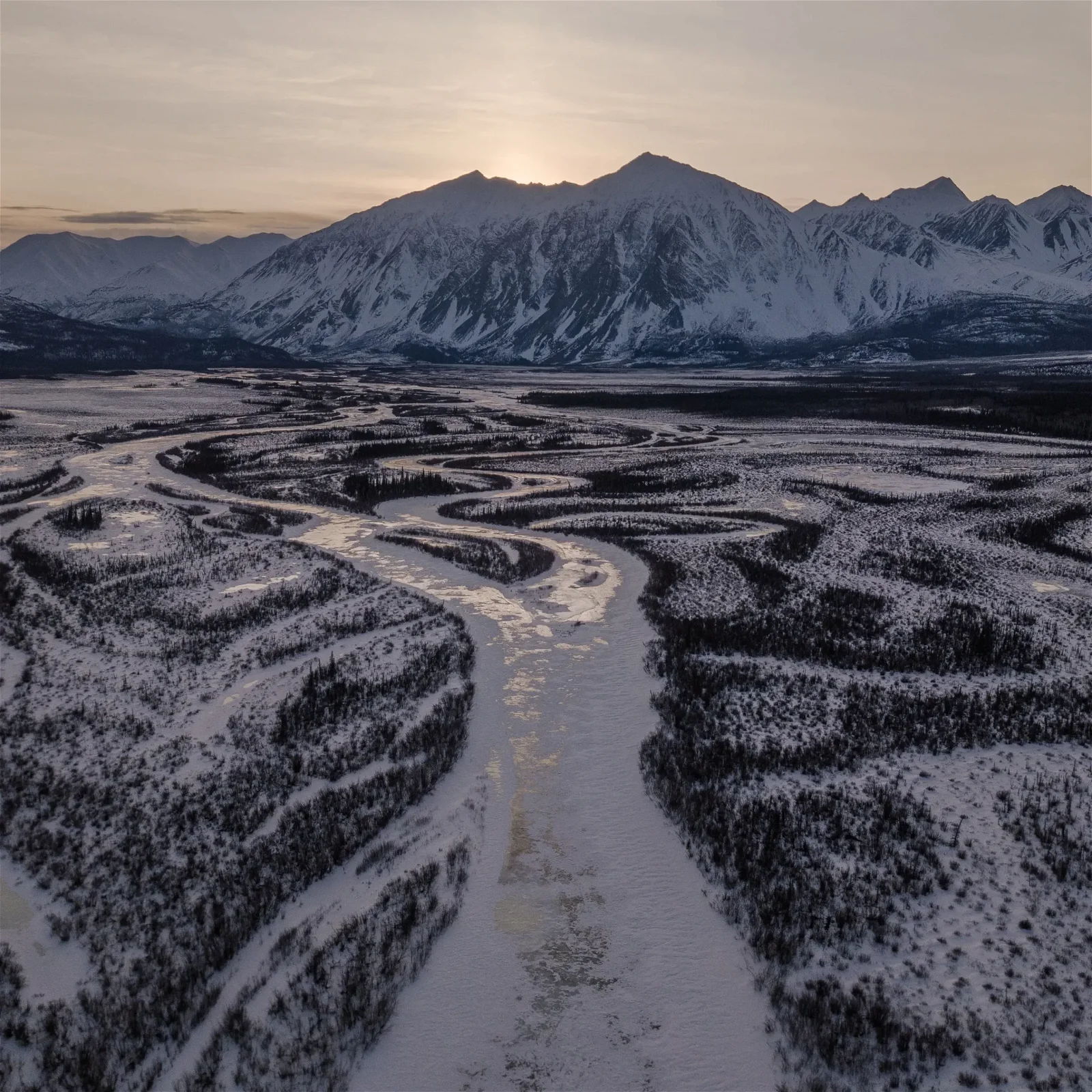 Scenic Winding Roads in Yukon's Forest with Majestic Mountains in the Background